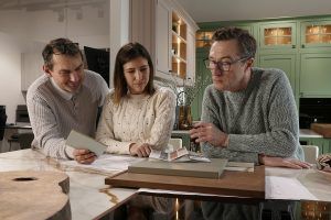 Bernard, Simona and Stefan reviewing bespoke kitchen design plans at Victoria Kitchens.