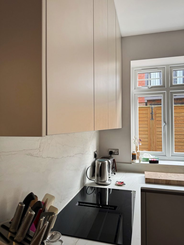 Vertical angle showing Rotpunkt Terra Grey base units and Dekton worktop with undermount sink, Victoria Kitchens