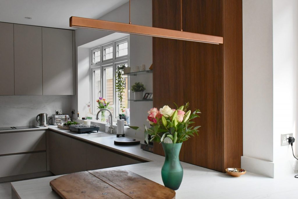 Open base cabinet unit showing internal storage organisation in a Rotpunkt kitchen, Victoria Kitchens