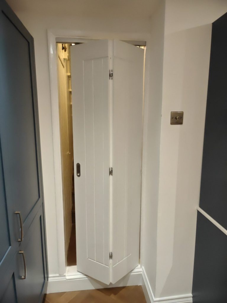 Kitchen folding door detail in newly installed Hague Blue shaker kitchen, SE7