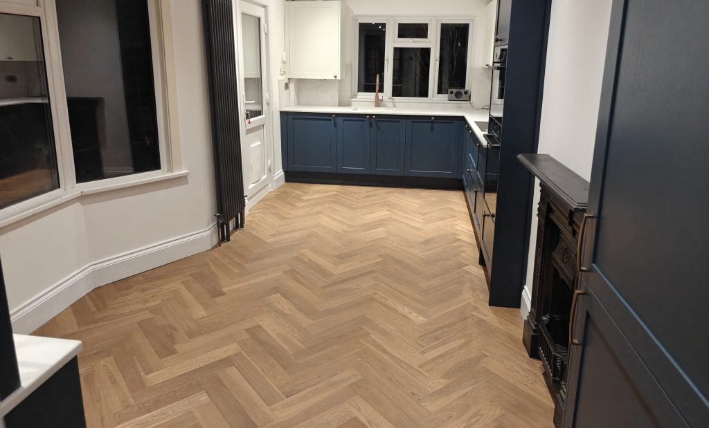 Full view of Hague Blue shaker kitchen with quartz worktops and copper boiling water tap, installed by Victoria Kitchens