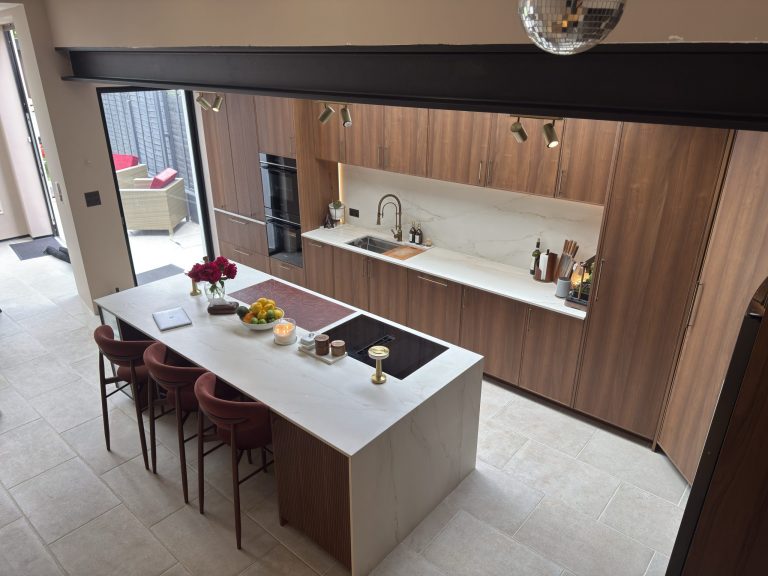 Rotpunkt walnut kitchen with Dekton worktops and glass-fronted dresser, designed by Victoria Kitchens, SE London