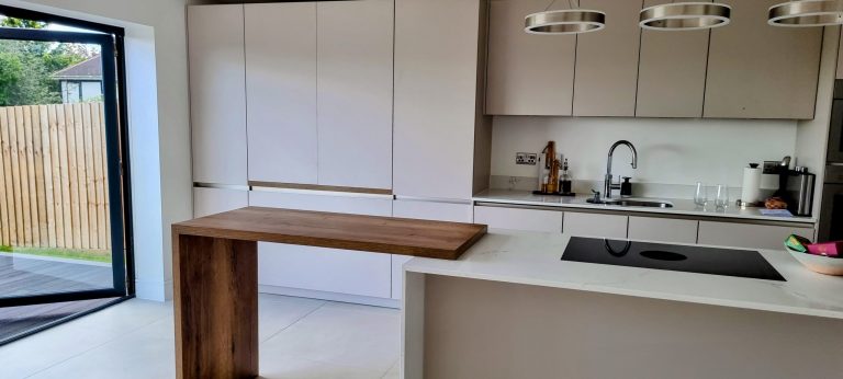Cashmere white matt handleless kitchen with slab doors and integrated appliances, North West London, Victoria Kitchens