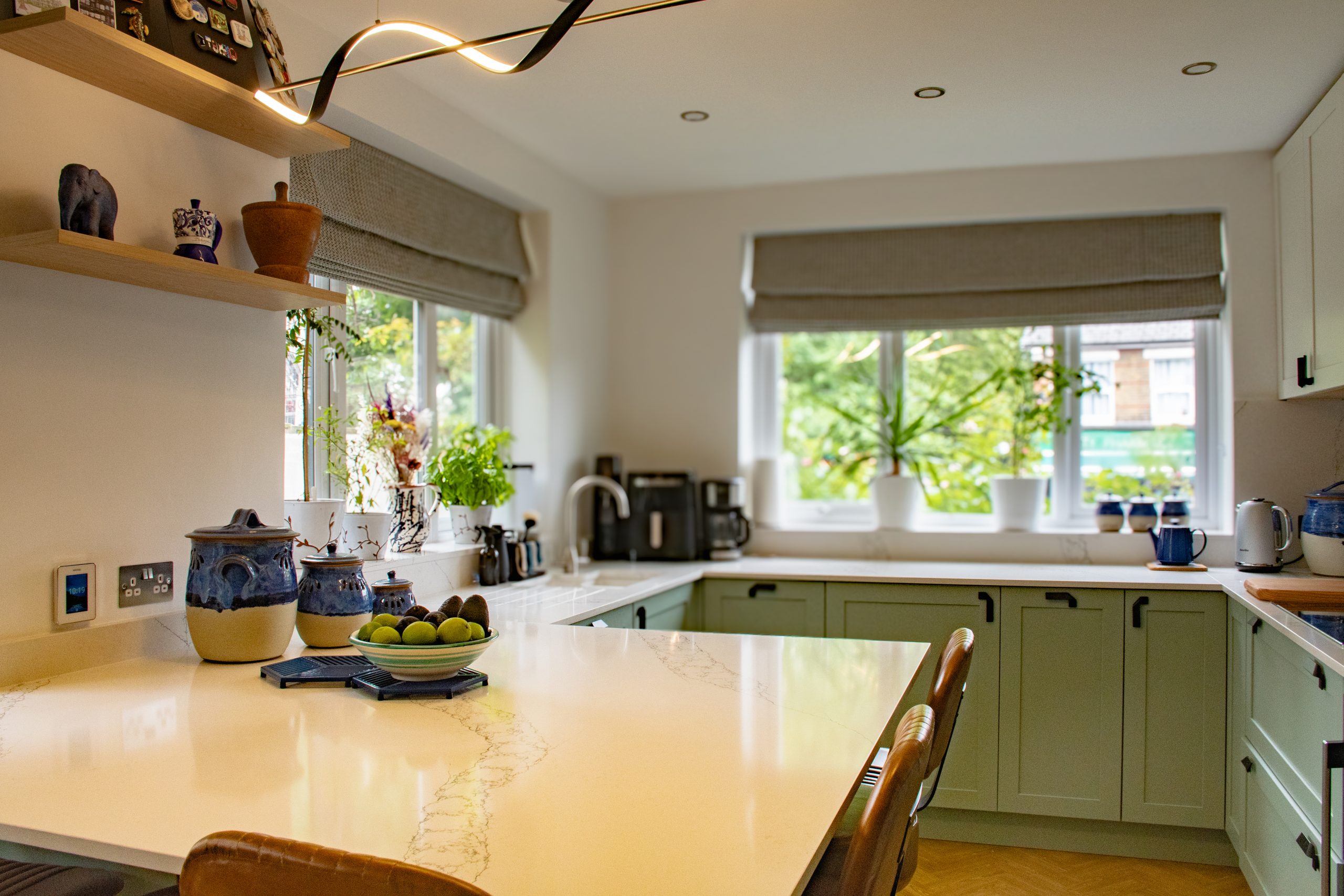Close detail of a honed marble worktop and solid oak dovetailed drawer in a luxury Shaker kitchen