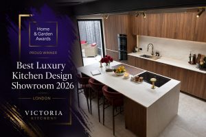 Victoria Kitchens award-winning luxury kitchen showroom featuring a bespoke walnut kitchen with a marble island, recognised as Best Luxury Kitchen Design Showroom 2026 in London.