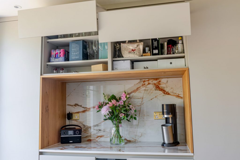Vertical bifold doors opening upward in contemporary Rotpunkt kitchen extension, Victoria Kitchens