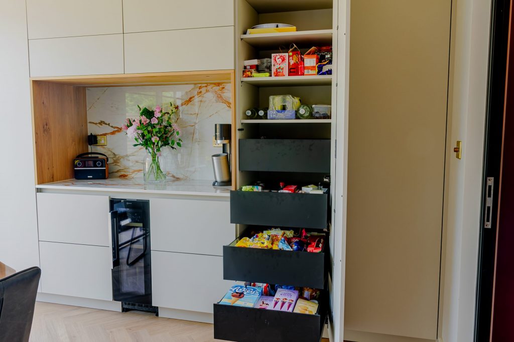Pull-out drawer storage in contemporary Rotpunkt cashmere kitchen with oak veneer cabinetry, Victoria Kitchens