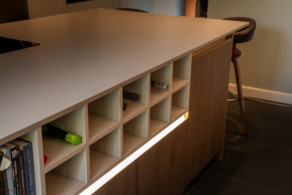 Bespoke custom wine storage integrated into kitchen island, Rotpunkt Kashmir Matt kitchen, Victoria Kitchens