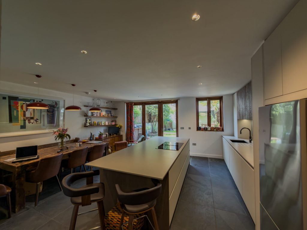 Wide shot of completed Rotpunkt Kashmir Matt kitchen with sandblasted timber finishes, island and integrated appliances, SE London