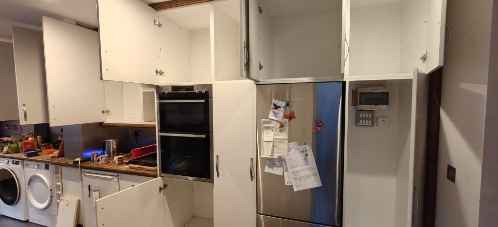 Outdated white kitchen before renovation, prior to Rotpunkt installation by Victoria Kitchens